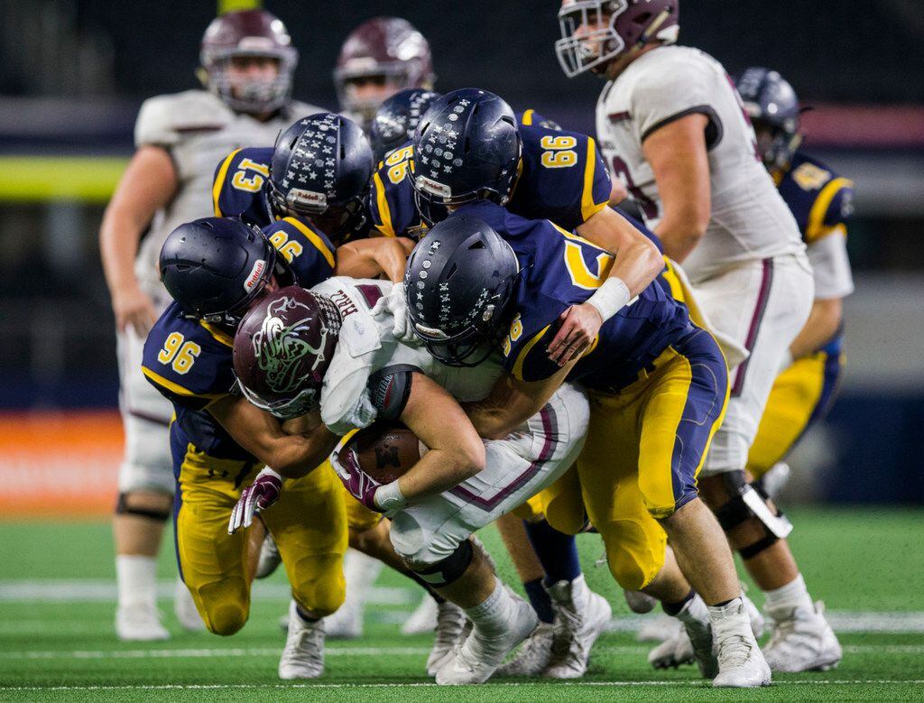 Highland Park defenders tackle Magnolia running back Mitch Hall (5) during the fourth...