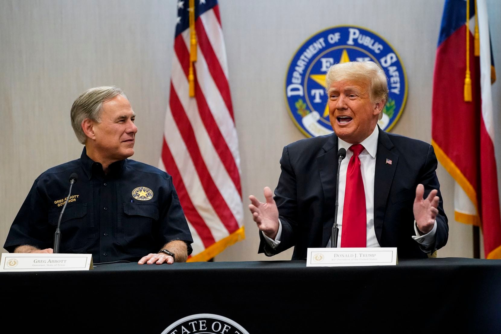 Texas Gov. Greg Abbott and former President Donald Trump attend a briefing on border...