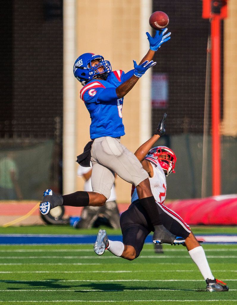 Duncanville wide receiver Marquelan Crowell (6) makes a leaping catch over St. John's...