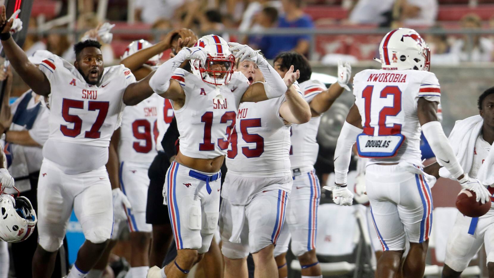 SMU safety Isaiah Nwokobia (12), right, ignites the Mustangs sidelines after intercepting a pass during second half action against Abilene Christian University. The two teams played their season opening football game at SMU's Ford Stadium in Dallas on September 4, 2021. (Steve Hamm/ Special Contributor)