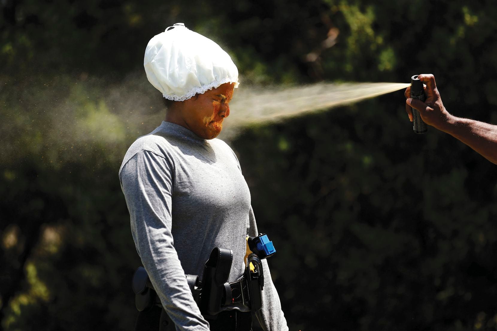 Recruit Anita Cruz gets sprayed in the face with Mace as part of her training at the Dallas Police Academy.