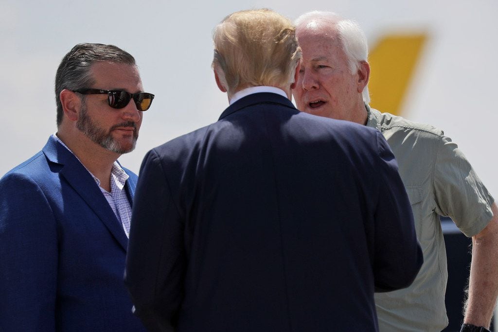President Donald Trump talks with Sens. John Cornyn (right) and Ted Cruz as he arrives at El...