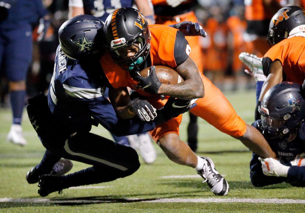Lancaster running back (2) Tre Bradford scores a first half touchdown as he's tackled by Frisco Lone Star linebacker Jayland Ford (24) during their Class 5A Division I Regional championship at Wilkerson-Sanders Stadium in Rockwall, Texas, Friday, December 6, 2019. (Tom Fox/The Dallas Morning News)