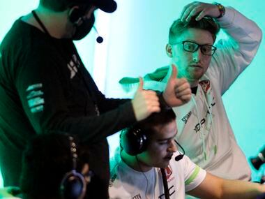 OpTic Texas player Seth "Scump" Abner, top right, listens to the direction of a technical...