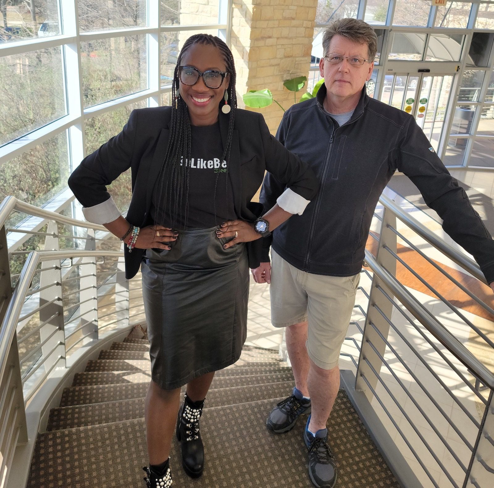 Erica Molett and Peter Bartnik stand in the sunny stairwell of the SMU Incubator.