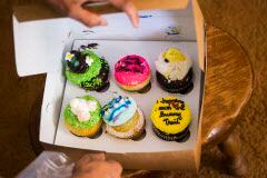 Leena Sanders opened a box of cupcakes brought by Henry S. Miller CEO Greg Miller to a...