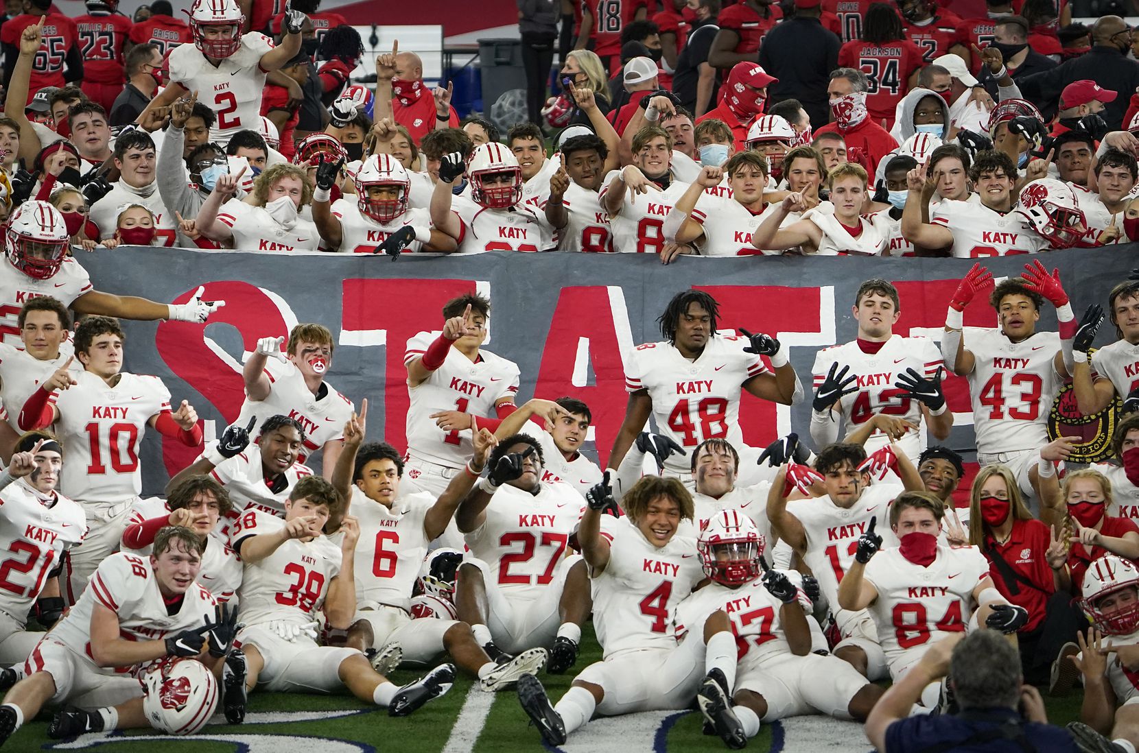 Katy players celebrate their victory over Cedar Hill in the Class 6A Division II state football championship game at AT&T Stadium on Saturday, Jan. 16, 2021, in Arlington, Texas. Katy won the game 51-14.