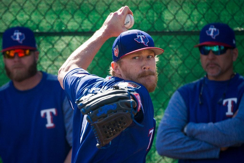 Texas Rangers pitcher Jake Diekman throws in the bullpen during a spring training workout at...