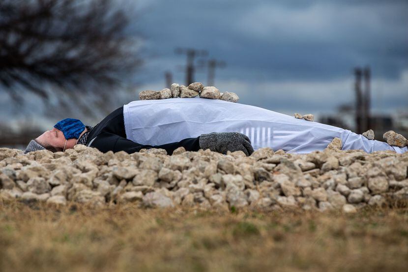 Erica Felicella lies on a bed of stones for her performance in the Cedars Tuesday.