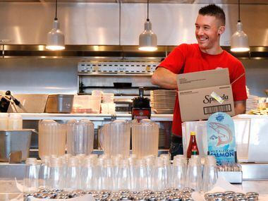 Corey Ahrens, 37, restocks condiments at Fish City Grill in Richardson. 