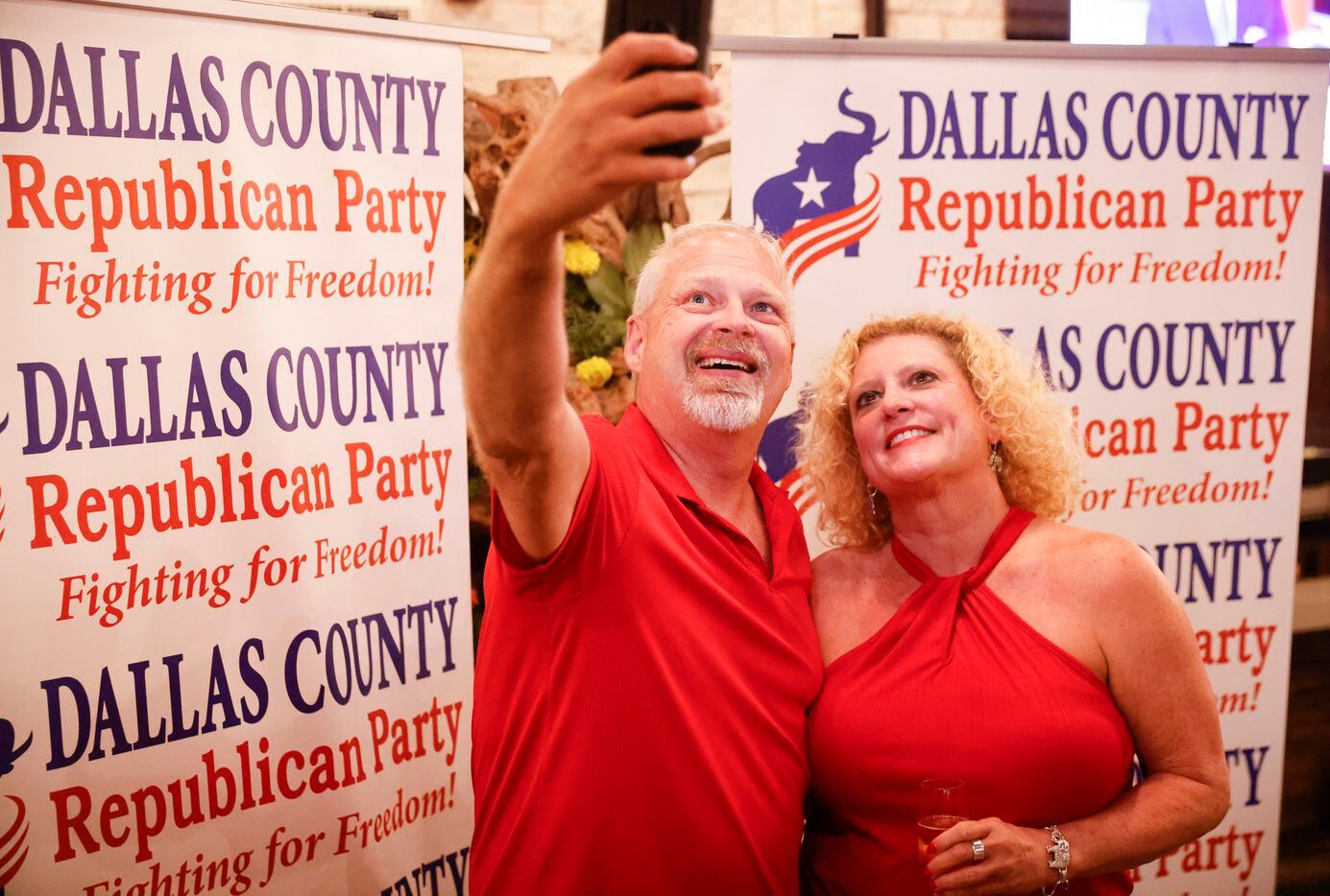 Supporters Chris Johnson, left, of Arlington and Kim Garrett of Dallas, take a selfie...