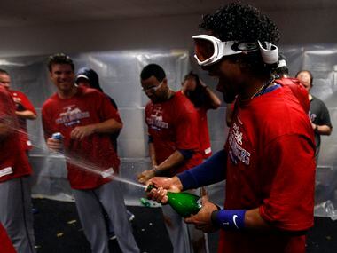 Texas Rangers Elvis Andrus sprays teammates after defeating the Tampa Bay Rays in game 5 of...