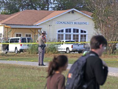 People walk past the community building near the First Baptist Church of Sutherland Springs,...