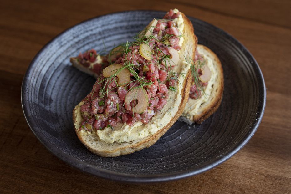 Encina's beef tartare is made with deviled egg puree, pickled celery and capers and served...