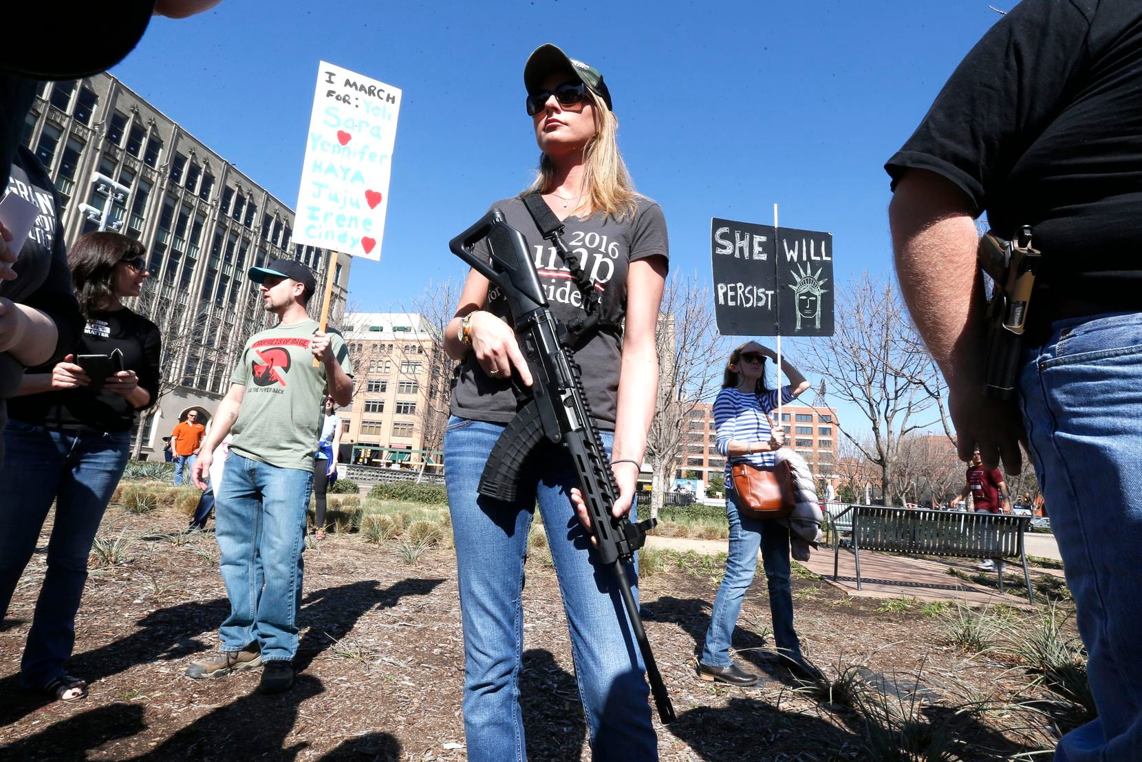 Brooke Wang, of Plano, Texas open carries a rifle while joining a very small group of...
