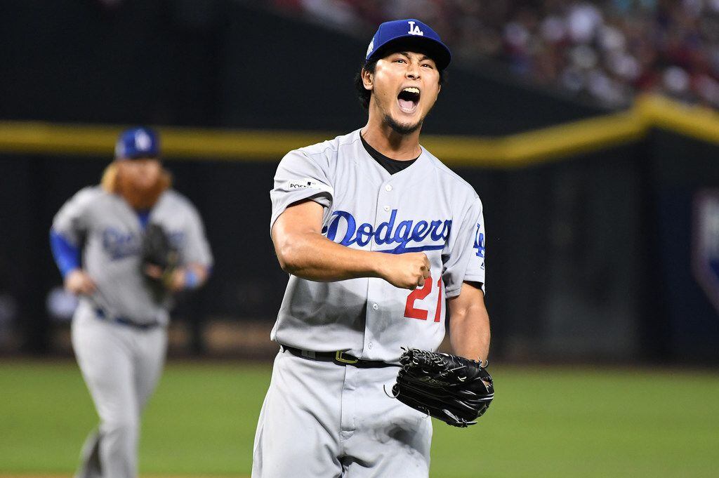 Dodgers pitcher Yu Darvish reacts after striking out Diamondbacks batter J.D. Martinez to...