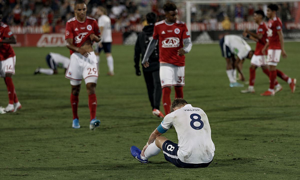 Aaron Walker of the Greenville Triumph sits dejected after the final whistle of the USL...