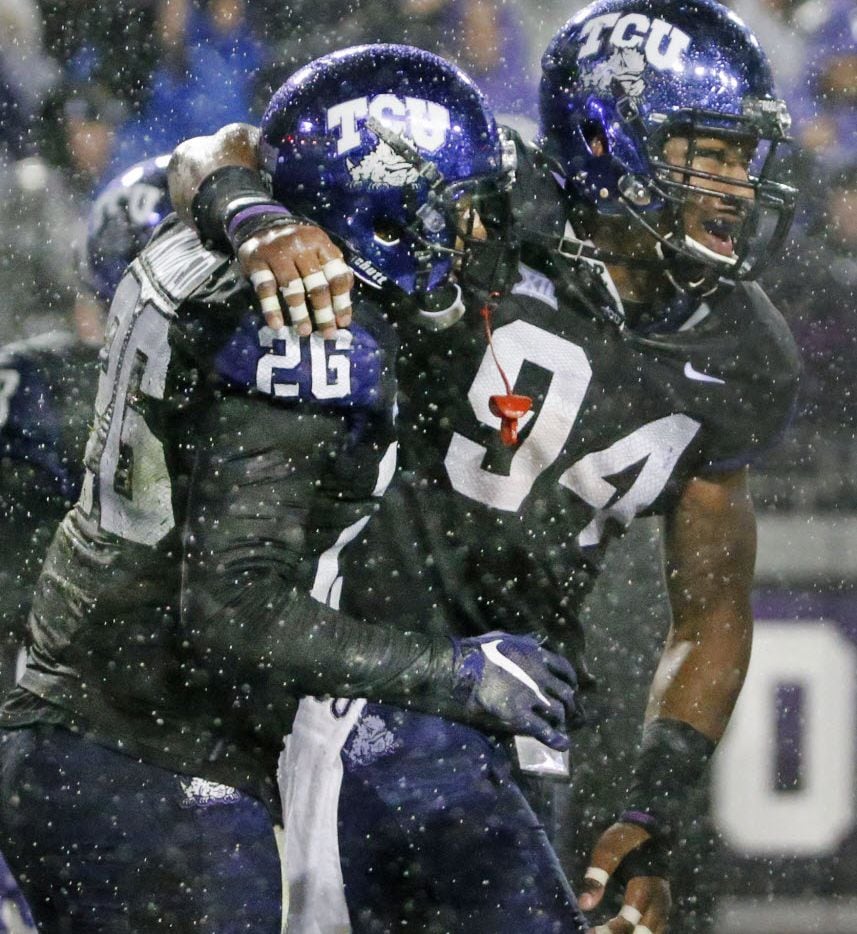 TCU Horned Frogs defensive end Josh Carraway (94) celebrates with TCU Horned Frogs safety...