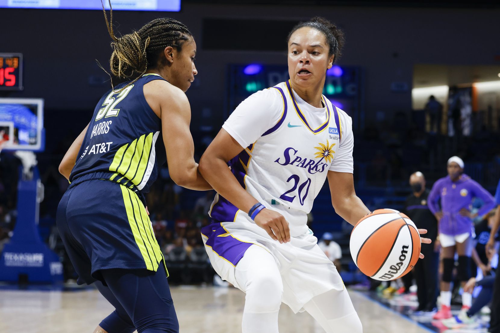 Los Angeles Sparks guard Kristi Toliver, right, is defended by Dallas Wings guard Tyasha...