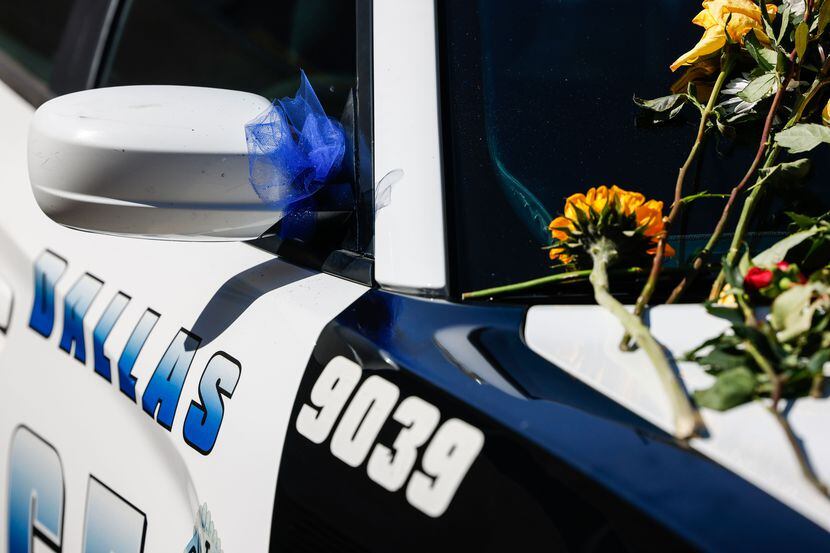 A Dallas Police car outside the northwest station as a memorial for officer Jacob Arellano...