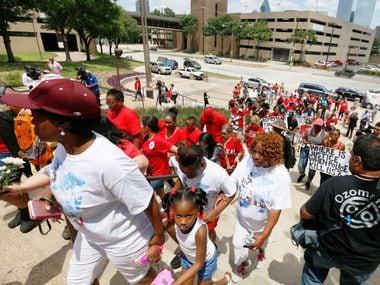 A crowd climbs the steps of the Frank Crowley Courts Building in Dallas Saturday May 13,...