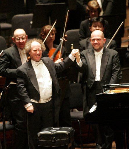 Jaap van Zweden (right) and pianist Jeffrey Kahane shook hands after the performance of Ravel's Concerto in G Major for Piano and Orchestra on Feb. 16, 2006, marking van Zweden's DSO debut.