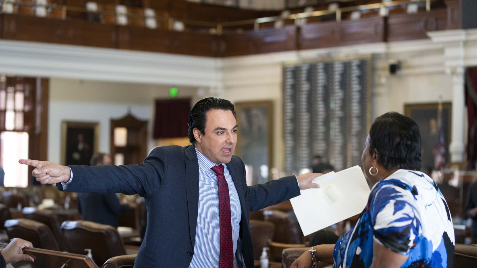 State Rep. Terry Canales, D-Edinburg, talks with Rep. Yvonne Davis, r, of Dallas on the...