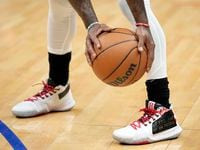 Dallas Mavericks guard Kyrie Irving warms up before an NBA basketball game against the Los...