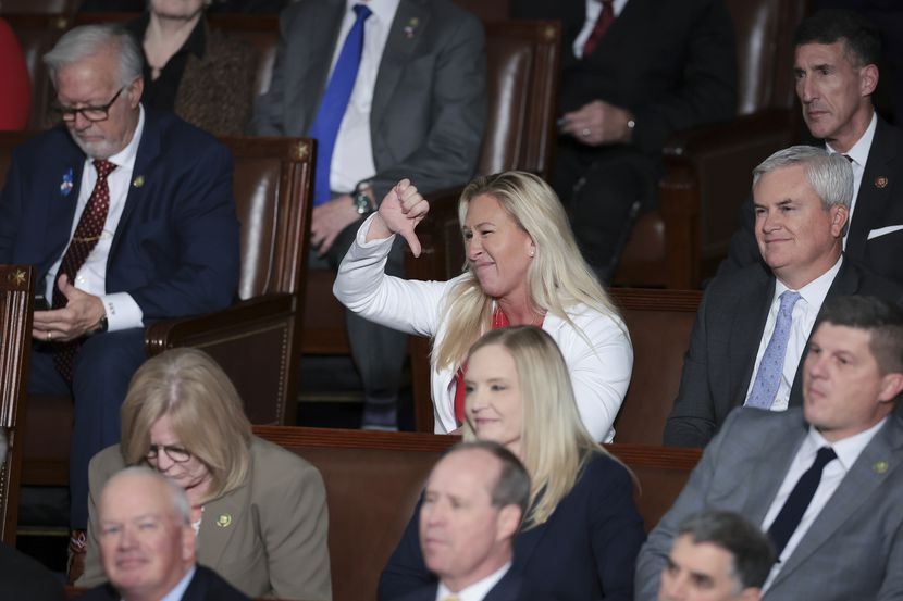 Rep. Marjorie Taylor Greene, R-Ga., expresses disapproval with a thumbs-down gesture as...