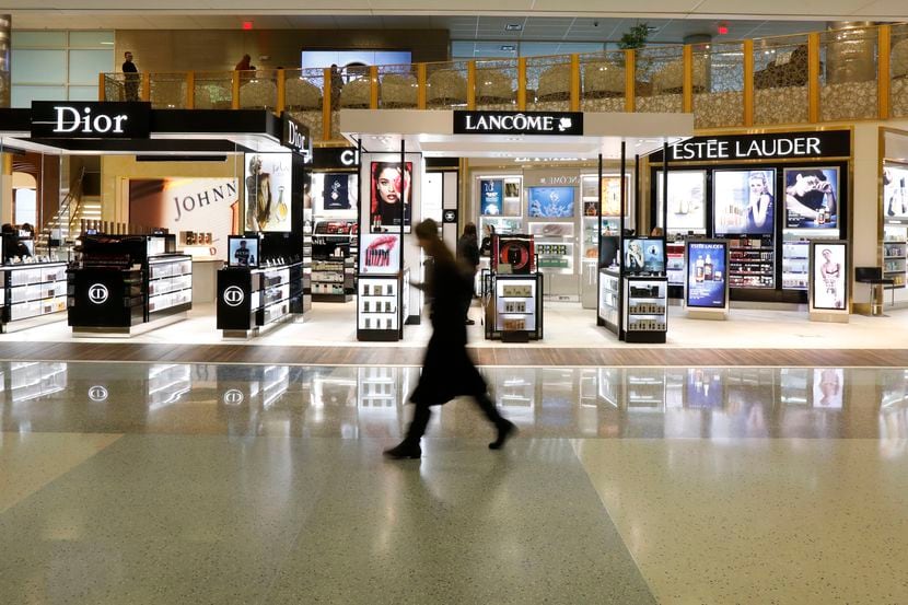 A passenger walks in front of the largest duty-free store in the Americas in Terminal D at...