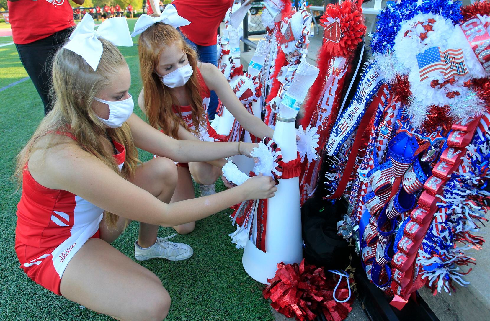 Terrell cheerleaders Jaci Merritt, left, and Paige Newberry adjust their homecoming...