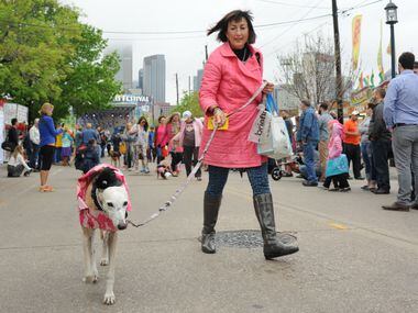 A matching dog and owner walk in the annual pet parade at the Deep Ellum Arts Festival.