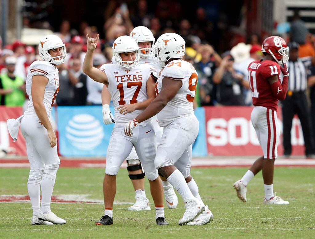 FILE - Texas kicker Cameron Dicker (17) celebrates with punter Ryan Bujcevski (8) and defensive lineman Gerald Wilbon (94) after Dicker made the game-winning field goal in the Red River Showdown at the Cotton Bowl in Dallas on Saturday, Oct. 6, 2018.