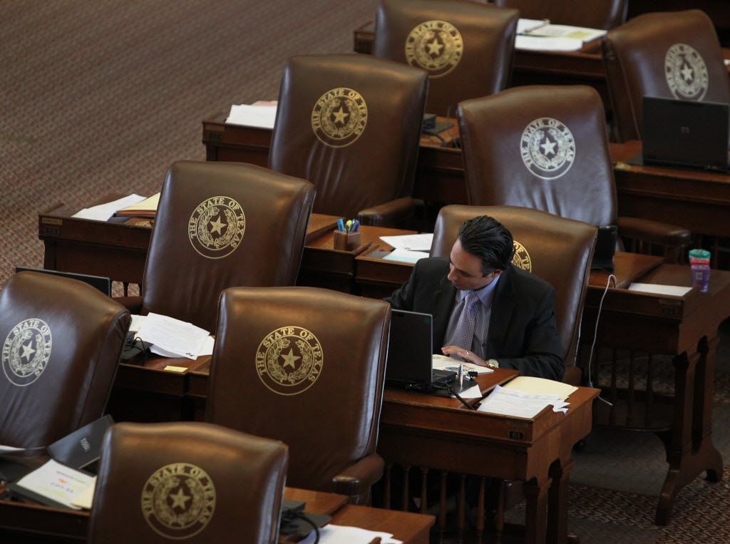 State Rep. Terry Canales, D-Edinburg, worked at his House desk in the Capitol in 2013. He passed a major bill this year that allows citizens to comment at the start and end of a public meeting — along with public comment during deliberations.