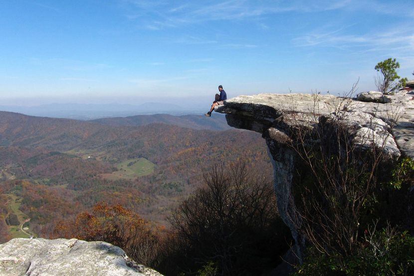 A hiker enjoys the view from atop McAfee Knob in the Blue Ridge Mountains of Virginia. 