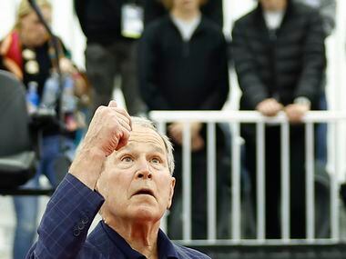 Former President George W. Bush tosses a coin before the start of the finals ATP Dallas Open...