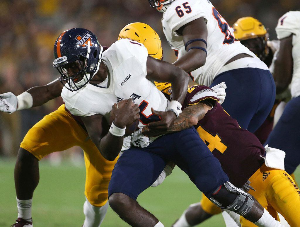 UTSA quarterback D.J. Gillins (15) is sacked by Arizona State's Chase Lucas, right, and...