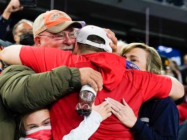 Denton Ryan assistant coach Shane Tolleson gets a hug from family in celebration of a 59-14...