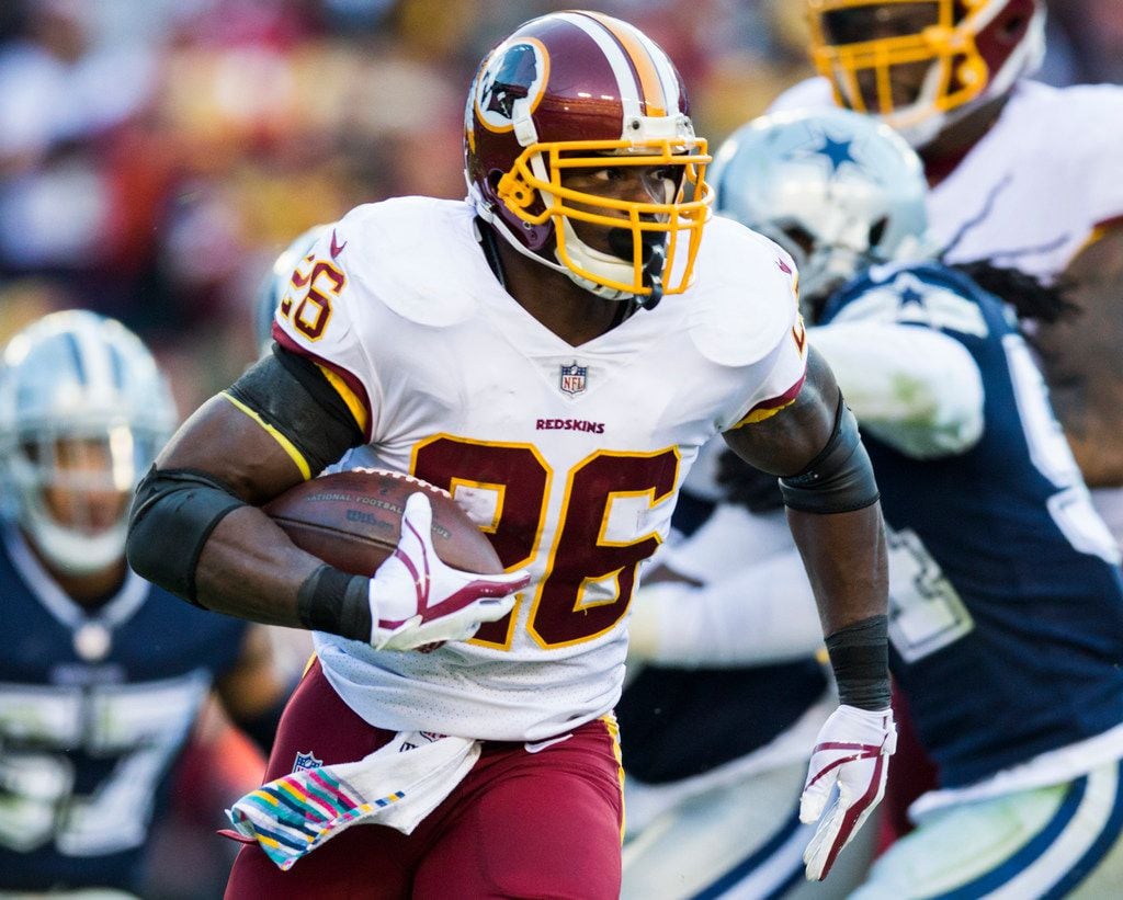 Washington Redskins running back Adrian Peterson (26) runs the ball during the first half of an NFL game between the Redskins and the Dallas Cowboys on Sunday, October 21, 2018 in Landover, Maryland. 