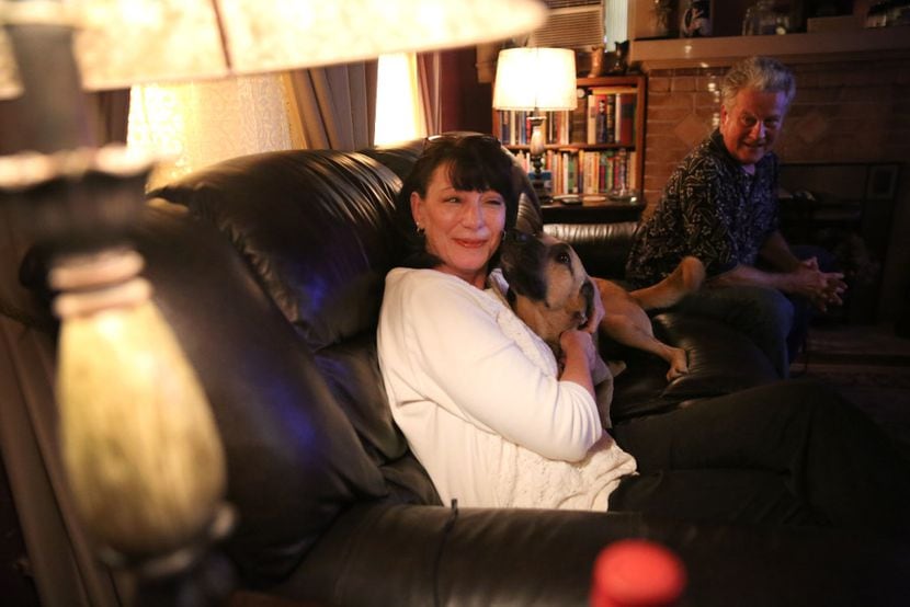 Dawn and Jeffery Humphrey relax with their dog at their Waco home.