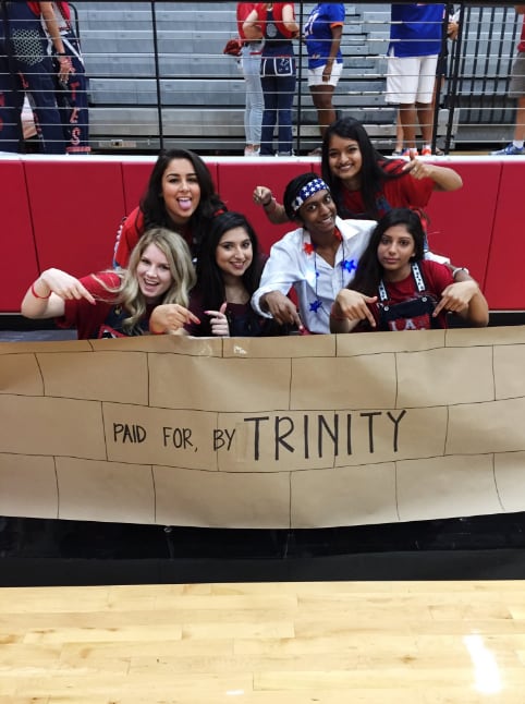Students with a pep rally sign that depicts the "wall" Donald Trump wants to build along the...