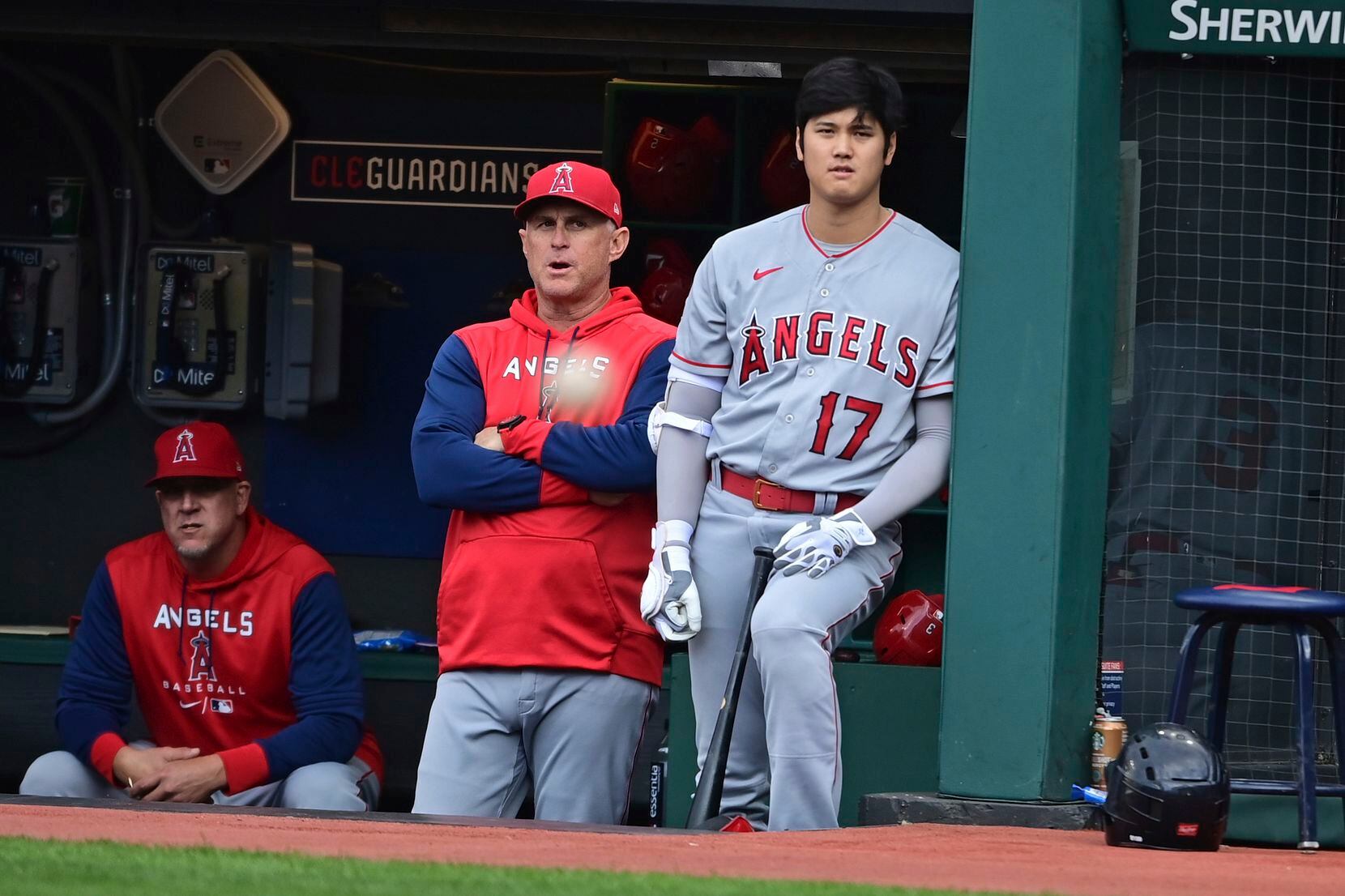 Los Angeles Angels interim manager Phil Nevin, left, and Shohei Ohtani stand in the dugout...