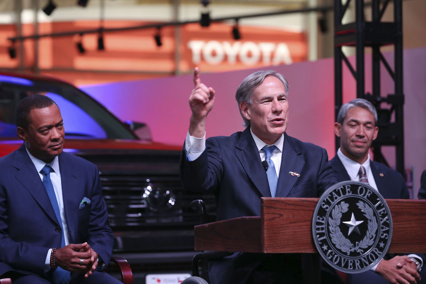 Texas Gov. Greg Abbott speaks during an event at the San Antonio Toyota plant, Tuesday, Sept. 17, 2019. Behind Abbott are Toyota Motor North America Chief Administrative Officer Christopher P. Reynolds, left, and San Antonio Mayor Ron Nirenberg, right. 