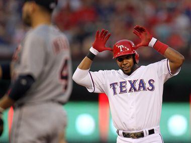Texas shortstop Elvis Andrus gives the "Antlers" sign after taking second on an overthrow of...