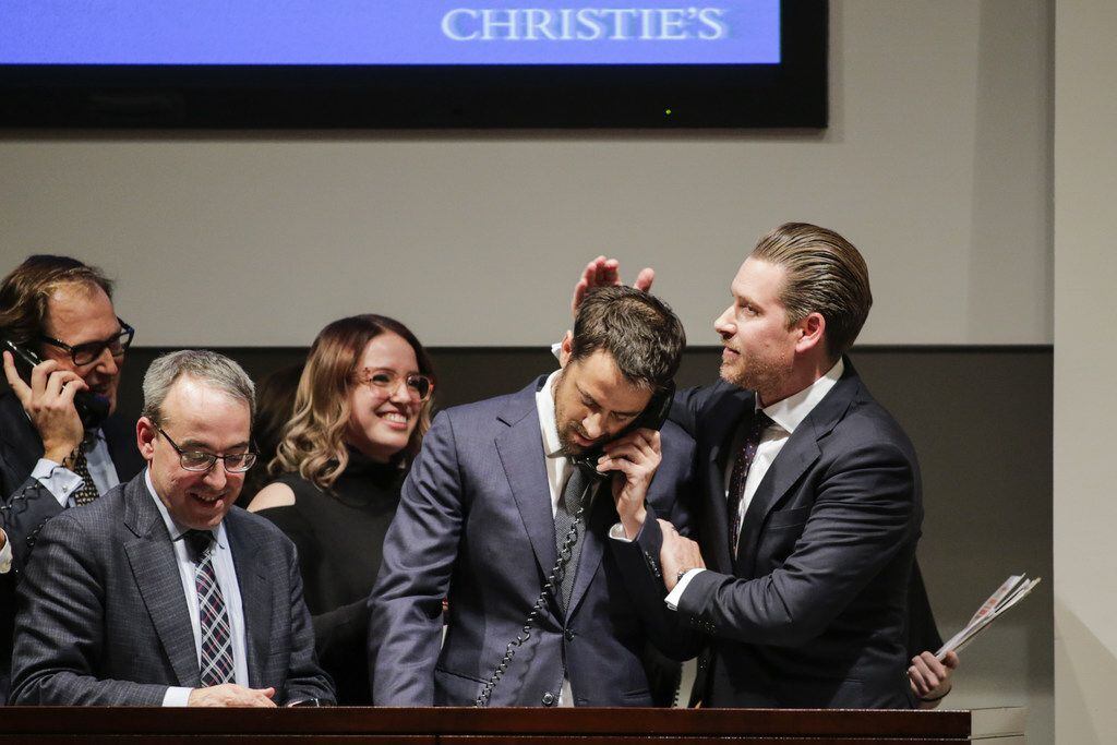 NEW YORK, NY - NOVEMBER 15: Agents celebrate after buying the auction of Leonardo da Vinci's...