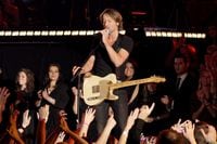 Keith Urban performs "You Gonna Fly" during the 45th Annual CMA Awards in Nashville, Tenn.,...