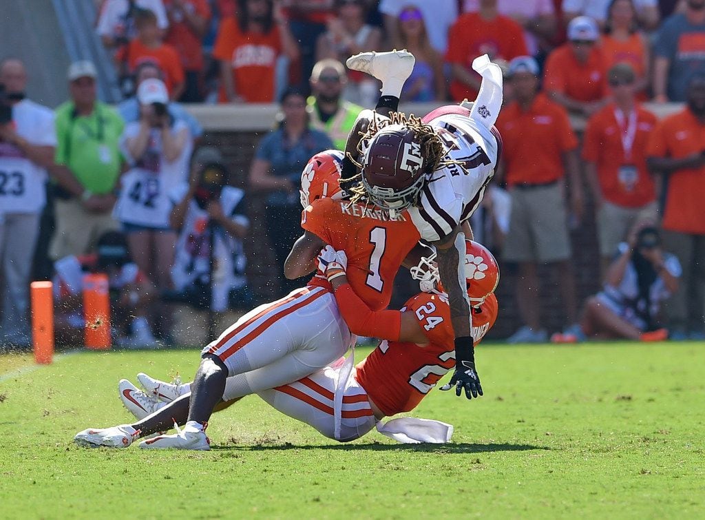 FILE - Texas A&M wide receiver Kendrick Rogers (top) is tackled by Clemson cornerback Derion Kendrick (1) and safety Nolan Turner during the first half of a game on Saturday, Sept. 7, 2019, in Clemson, S.C. (AP Photo/Richard Shiro)