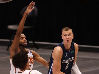 Dallas Mavericks forward Kristaps Porzingis (6) looks to shoot as Phoenix Suns forward Mikal...