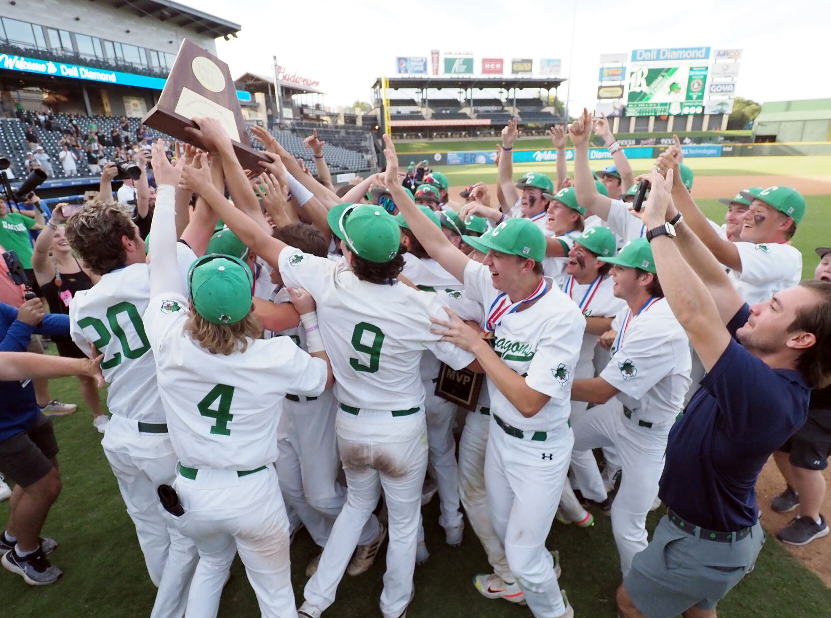 Southlake Carroll players hoist the first place trophy after defeating San Antonio Reagan in...