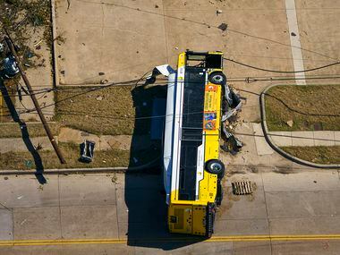 A overturned DART bus is seen near Walnut HIll Lane and Denton Drive on Monday, Oct. 21,...